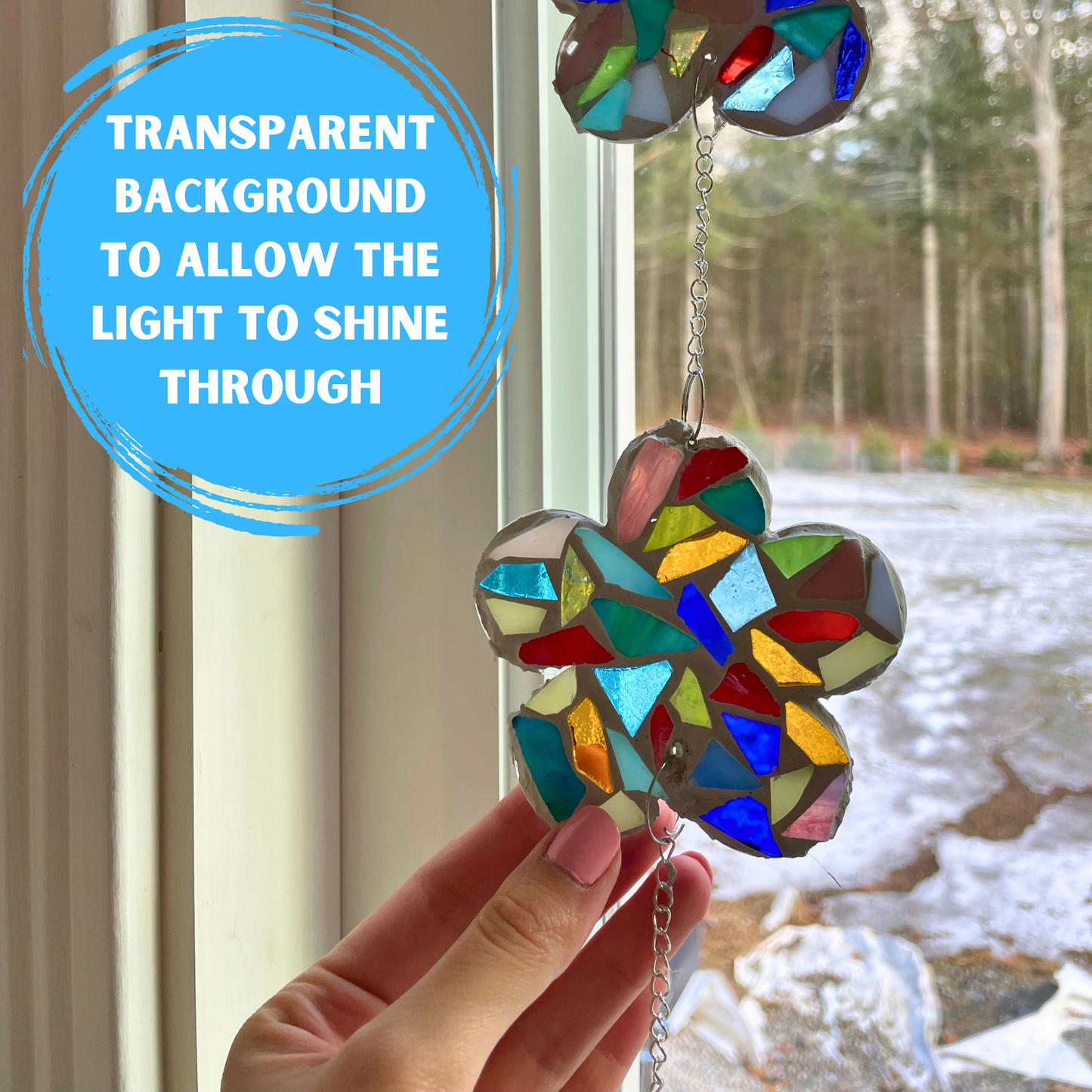 Finished stained glass mosaic suncatcher in the light with the note that the backing is transparent to allow the light to shine through.